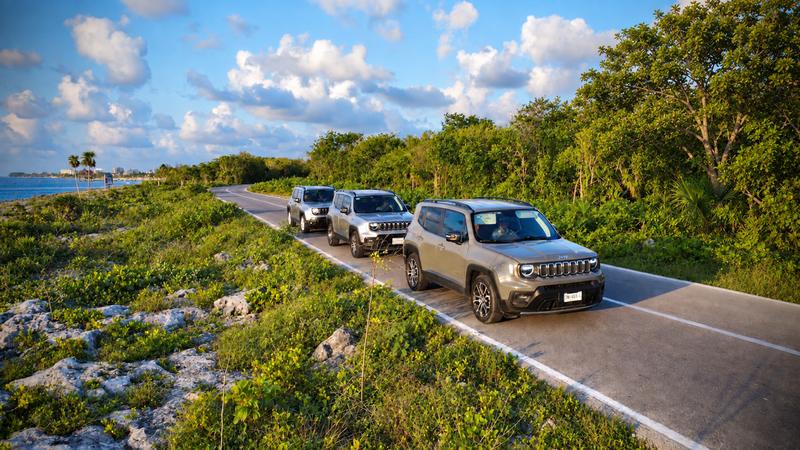 Three private Jeeps on the coastal road in Cozumel, the sea on one side and jungle on the other